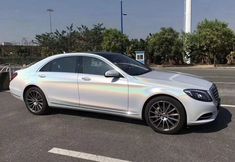 a white mercedes s - class parked in a parking lot