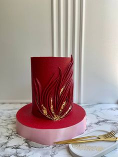 a red hat with gold sequins on it and a pair of golden forks