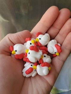 small plastic chickens in the palm of someone's hand