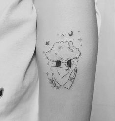 a woman's arm with a black and white drawing of a cloud on it