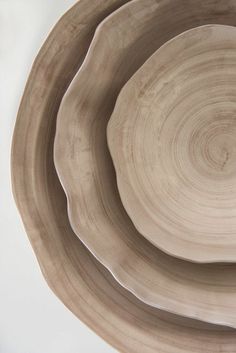 three wooden bowls stacked on top of each other