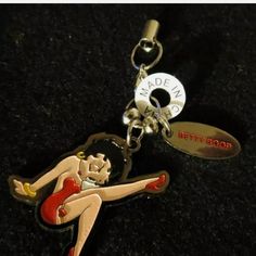 a keychain with a pin up girl on it's front and bottom