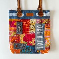 Marigold Bohemian Shoulder Tote Bag Embrace the vibrant essence of bohemian style with the Marigold Bohemian Shoulder Tote Bag. This lively tote is a patchwork of vivid colors and eclectic patterns that evoke a sense of adventure and free-spirited charm. From the bustling markets to the tranquility of a park, carry a splash of color and joy wherever you go. The bag is adorned with a mix of textiles and designs, creating a beautiful collage that's as unique as the person carrying it. The sturdy s Handmade Tote Bags, Artsy Bag, Beautiful Collage, Handmade Tote, Work Tote, Tote Bags Handmade, Upcycled Denim, Eco Friendly Fashion, A Park