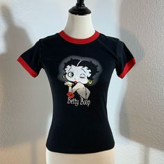 Nwt Betty Boop Black Cotton Tee Shirt Size: Medium 100% Cotton In New With Tag Condition! Thanks So Much For Looking! Black Retro Cotton Tops, Black Retro Crew Neck Top, Fitted Retro Black Top, Black Fitted Retro Top, Retro Fitted Black Top, Fitted Black Retro Top, Betty Boop Clothes Aesthetic, Betty Boop Pajamas, Betty Boop Tee Shirts