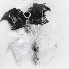 Elevate your gothic-inspired look with these striking hairclips. Each hairclip features intricately designed demon wings and a rhinestoned cross charm. The Jirai Kei bowknot adds a touch of kawaii flair to these edgy accessories. Perfect for adding a bold statement to your hairstyle, these hairclips are a must-have for anyone looking to embrace a dark, yet stylish aesthetic.   Please note that this product includes a pair of hairclips only. Cross Bow Accessories, Black Swan Accessories, Dark Coquette Accessories, Angelic Accessories, Vampires Kiss, Cross Accessories, Angel Accessories, Emo Jewelry