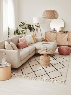 a living room filled with lots of furniture and decor on top of a white floor