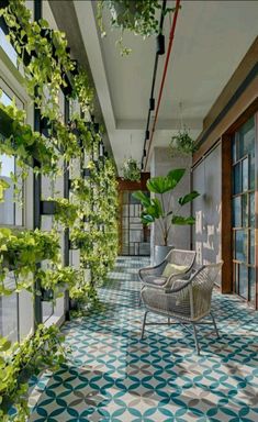 an outdoor patio with plants growing on the wall, and chairs in the foreground