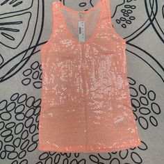 Sequin Tank Top In A Bright Neon Orange And Cream Design Sequins Are Very Light & Appears Different Depending On Lighting (Please See Photos For Different Angles) Stretch Orange V-neck Top, Orange Stretch V-neck Top, Spring Orange V-neck Tank Top, Orange Stretch Summer Tank Top, Orange V-neck Tank Top For Spring, Orange Stretch Tank Top For Summer, Orange Stretch Summer Tops, Spring Stretch Orange Tank Top, Orange Stretch Tank Top For Spring