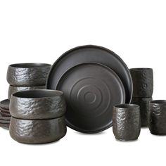 an assortment of black dishes and cups