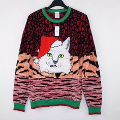 an ugly sweater with a cat wearing a santa hat on the front and green eyes