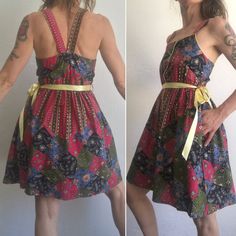 "Vintage provençal dress from the 70s Made in France 1970s Short cotton dress with floral / paisley pattern in red, black, green, blue and yellow colors. Elastic waist and upper back part. Yellow finishing on neckline and button tape. Front buttoning with 6 golden metal heart buttons . All buttons have floral ingraving. Straps in the same fabric that unite on the back . Light yellow satin lace . Flared skirt. In very good condition. Material: cotton Size: XS (EU 36) (estimated) Our model wears u Vintage Sleeveless Patterned Dress, Retro Cotton Dresses For Festival, Fitted Bohemian Dresses With Vintage Pattern, Fitted Cotton Dress With Paisley Print, Fitted Hippie Printed Dresses, Fitted Vintage Dress In Patterned Color, Vintage Fitted Patterned Dress, Fitted Vintage Patterned Dress, Fitted Patterned Dress For Festival