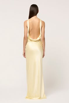 The signature Michael Lo Sordo maxi dress silhouette is reinvented for the season. Featuring a dramatic cowl neck, this maxi gown of 100% silk drapes elegantly over the body and is cut on the bias for a flattering fit. Made in pale yellow, this is a dress that you can style a myriad of ways for endless reinvention. Also available in White and Pink. Light Gold Satin Dress, Cowel Neck Dress, Silk Full Length Dress, Yellow Gold Bridesmaid Dresses, Yellow Silk Prom Dress, Pastel Yellow Formal Dress, Butter Yellow Dress, Pale Yellow Prom Dress, Valedictory Dress