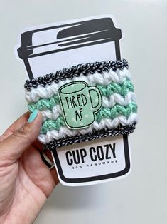 "This is THE cup cozy for those of us who are tired AF!! It makes an amazing gift and will fit on almost any hot/cold coffee cup. Since this item is handmade, stretching is expected. The cute coffee cup feltie is hot glued on, so take care when cleaning (see more info below) Details: Fiber: 100% acrylic yarn Care: should be spot cleaned (only when necessary) and dried flat to give your cozy a longer life. Approximate size: Width: 4\"  Height: 3\"  Pattern note: You can find the crochet pattern h Cold Coffee Cup, Coffee Cozy Pattern, Tired Af, Crochet Coffee Cozy, Crochet Coffee, Cup Sleeves, Coffee Cup Sleeves, Cute Coffee Cups, Gift Wrap Box