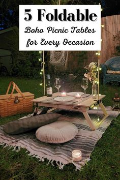 a picnic table with candles on it in the grass