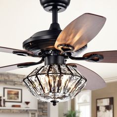 a ceiling fan with two light bulbs and a glass caged light fixture hanging from the ceiling