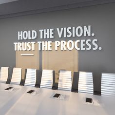 a conference room with chairs and a sign that says hold the vision trust the process