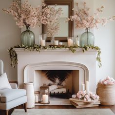 a living room filled with furniture and a fire place covered in pink flowers on top of a mantel