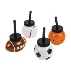 three plastic sports balls with black tops and one has a basketball on it, the other has a soccer ball