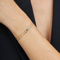 A minimalistic and delicate bracelet but with an impressive presence. A design element in the form of two oppositely threaded hooks. In the center of the element is embedded a Chatham emerald of a size close to 3 mm, which gives the bracelet a powerful look without detracting from its delicacy. In the design of the collection, we took care of all the small details and the closure of the bracelet is also designed under the same conceptual idea for the eyes of the wearer only. The bracelet is insp Minimalist Emerald Jewelry For Formal Occasions, Modern Green Bracelet Strap Jewelry, Modern Green Jewelry With Bracelet Strap, Green Modern Jewelry With Bracelet Strap, Minimalist Yellow Gold Bracelet With Birthstone, Minimalist Yellow Gold Birthstone Bracelets, Minimalist Yellow Gold Bracelet For May Birthstone, Female Suit, Minimal Jewellery