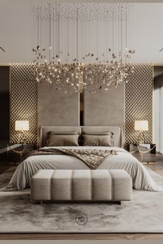 a large bed sitting under a chandelier in a bedroom