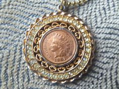 Luck be a lady tonight with this fun nostalgic vintage medallion fashion goldtoned 1901 indian head penny pendant necklace! The coin pendant is bedecked with clear rhinestones for some sparkle and sold on a goldtoned 22 inch ball chain. It measures 1.5 inches across and shows some signs of wear which actually imbues some love and character to this piece. Hit the slots or craps table with this baby on and get ready to rack it in or rub some luck on another for a cool coin collector, gambling enth Victorian Jewelry With Coin Pendant, Vintage Charm Pendant Coin Necklace, Antique Gold Coin Pendant Jewelry For Collectibles, Vintage Pendant Coin Necklace With Charm, Vintage Coin Medallion Necklace, Vintage Medallion Coin Necklace, Antique Gold Jewelry With Coin Pendant For Collectors, Antique Coin Necklaces For Anniversary, Vintage Gold Coin Necklace