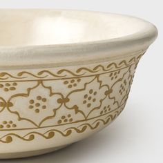 a white bowl with gold designs on it