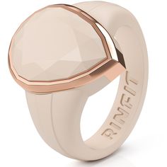 a ring with an oval face and rose gold accents