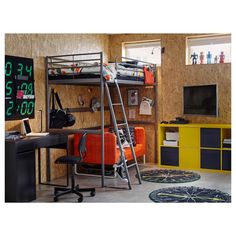 a room with bunk beds, desk and chair in it's center is shown