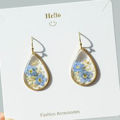 Welcome to my shop! Nice to meet you:) ⭐Product feature: * Pendant Size : 17 mm(width),25mm(length) ❀ Handmade from Forget me not real pressed flowers and resin, these earrings are unique, lightweight and eye catching! ❀Real flower earrings are one of the perfect gifts for your sister, female friend, girlfriend, family, lover, daughter, wife,mother and etc., they can represent your love or your name.  ❀Due to the handmade nature of this product, slight variations may occur, however, the design remains as similar as possible. ⭐Product Service: ❀ Well packaged: You can choose simple packaging or gift box packaging. ❀Write greeting cards for free: Maybe you are choosing a special gift for the person you love. We can write love and blessings to someone special on your behalf. If you need it, p Gold Pressed Flower Earrings For Mother's Day, Gold Hypoallergenic Resin Flower Earrings, Hypoallergenic Gold Flower Earrings With Resin, Hypoallergenic Gold Resin Flower Earrings, Gold Teardrop Flower Earrings With Pressed Flowers, Cute Gold Flower Earrings For Gift, Dangle Flower Earrings With Natural Inclusions As Gift, Clear Flower Drop Earrings Gift, Clear Flower Drop Earrings For Gifts