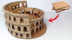 a cardboard model of the colossion is shown with an arrow pointing to it