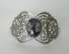 "This beautiful silver plated filigree cuff bracelet has a silver plated triple moon design, amethyst setting with silver plated embellishments and silver plated chain. 6\" long adjustable to 9\" long. Silver plated lobster clasp." Spiritual Silver Decorative Jewelry, Spiritual Decorative Silver Jewelry, Gothic Bangle Bracelet For Gift, Silver Gothic Bracelets For Festival, Handmade Silver Amethyst Cuff Bracelet, Bohemian Amethyst Jewelry With Intricate Design, Adjustable Filigree Bohemian Cuff Bracelet, Gothic Silver Bracelet, Bohemian Purple Filigree Jewelry