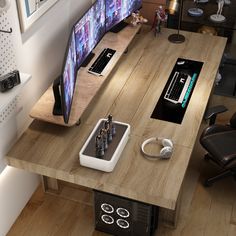 a computer desk with two monitors and headphones on it