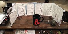 a wooden table topped with coffee cups and menus next to figurines on top of it