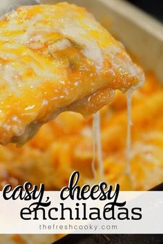 a cheesy enchiladas being lifted from a casserole dish