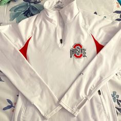 Lightweight Fleece Lined Ohio State University 1/4 Zip Pullover. Zippered Pockets. Thumbholes. Embroidered Logos. White Long Sleeve Activewear For Fall, White Fleece Half-zip Top, White Fleece Winter Activewear, White Fleece Activewear For Winter, Winter White Fleece Activewear, White Long Sleeve Fleece Activewear, White Half-zip Winter Top, Casual White Half-zip Activewear, Fall White Moisture-wicking Activewear