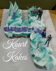 cupcakes with frosting and figurines in the shape of a frozen lake