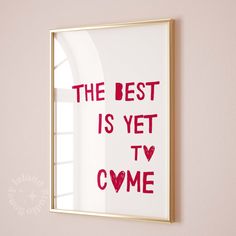 the best is yet to come framed art print in gold frame on pink wall with window