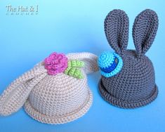 two crocheted hats with ears and flowers on them, one has a flower in the middle