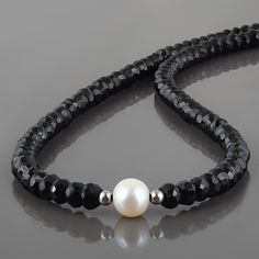 "Black Spinel Pearl Jewelry  Natural -Black Spinel & Pearl Necklace Handmade Necklace Gemstone : Spinel & Freshwater Pearl Gemstone Color : , Black Treatment : Natural Gemstone Size : 5MM Spinel,8MM Pearl Gemstone Shape : Rondelle,Round Gemstone Finish : Faceted,Fine Stone Beads : 38CM Chain Length With Lock- 7CM Silver Lock : 8MM Total Length Of Necklace : 45 Cm Can be Personalized : Yes Necklace Carat Weight : Approx 80 carat Materials : 925 Sterling Silver Plating : Yellow Gold Plating, Rose Pearl Necklace Handmade, Black Spinel Necklace, Spinel Necklace, Spinel Jewelry, Necklace With Pearl, Necklace Stone, Pearl Choker Necklace, Personalized Pendant, Black Spinel