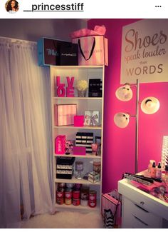 a room with pink walls and white shelves filled with makeup, cosmetics and other items