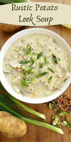 a white bowl filled with soup on top of a wooden table next to potatoes and green onions