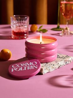 a pink candle sitting on top of a table