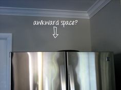 a refrigerator with the words awkward space written on it's side and an arrow pointing up