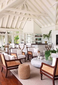 a living room filled with lots of white furniture