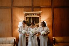 three bridesmaids standing in front of a mirror