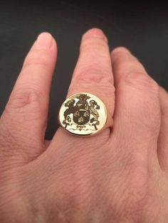 "Custom Family Crest, Coat of Arms Ring, Knight Ring, Man Gold Ring, Custom Signet Ring, Custom Coat of Arms Engraved Signet ring with Round Seal- Best quality 18k Gold Plate or sterling silver Special technique of black laser engraving Seal Diameter: 15 mm Please note in the \"notes to seller\" at checkout. : * state your ring size * letter you want to apper The product will arrive to you packed in gift box and padded envelope to maintain the product Our jewelry are water resistant and comes wi Classic Coat Of Arms Ring, Anniversary Coat Of Arms Signet Ring, Anniversary Signet Ring With Coat Of Arms, Round Jewelry With Coat Of Arms For Gifts, Elegant Round Jewelry With Coat Of Arms, Heirloom Coat Of Arms Jewelry For Anniversary, Elegant Round Coat Of Arms Jewelry, Gift Signet Ring With Coat Of Arms, Gift Coat Of Arms Signet Ring