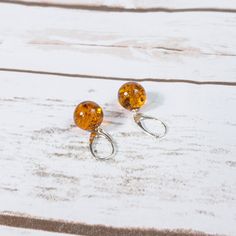 "These particular earrings are made of Baltic amber and sterling silver (.925). Highly polished amber spheres are attached to sterling silver hangers. Lever back clasp. Specification: Length: 3cm (1.2\") Amber size: 1.3cm (0.51\") Product may be a bit different from images because shapes and size - 10%) of stones may vary. Amazing and charming artistic amber jewellery inspired by nature only here. Gemstones made individually - every amber has a unique structure, tone and texture. Our jewellery h Amber Drop Earrings With Ear Wire, Amber Dangle Earrings With Lever Back Ear Wires, Elegant Amber Round Bead Earrings, Amber Dangle Earrings With Lever Back, Amber Dangle Earrings For Anniversary, Hypoallergenic Amber Dangle Earrings, Hypoallergenic Beaded Earrings For Anniversary, Hypoallergenic Amber Sterling Silver Earrings, Round Clip-on Earrings With Lever Back For Gift