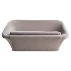 a gray bath tub sitting on top of a white wall