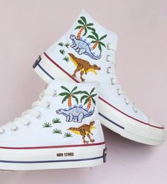 Embroidery converse/Custom Embroidered dinosaur shoes/Custom converse high tops embroidered dinosaur/gift birthday shoes/Personalized name   💸 Price includes Converse Shoes and floral embroidery as shown 🌸 You can send me your Converse/Vans shoes or I can buy them for you. We stock all the Converse and Vans shoes you want, if you want other Converse/Vans shoes in the store, please message us. Your embroidered Converse/Vans shoes will be available for shipping in 7-15 days. 🌸 I started hand embroidering on fashionable clothes and handbags over 20 years ago - and now on CONVERSE/VANS shoes, an American icon, a must-see classic! I'm excited to give your Chuck Taylor shoes a new look with beautiful, nature-inspired embroidery. All images, designs and text used by CUSTOMSHOEDESIGNSOHO are co Casual Sneakers With Custom Embroidery, Casual Custom Embroidery Lace-up Sneakers, Casual High-top Sneakers With Custom Embroidery, Custom Converse High Tops, Embroidered Dinosaur, Converse Chuck 70s, Embroidery Converse, Dinosaur Shoes, Painted Converse