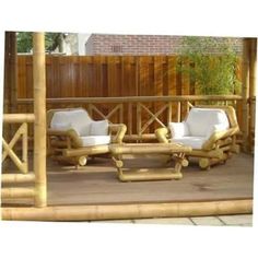 two white chairs sitting on top of a wooden deck